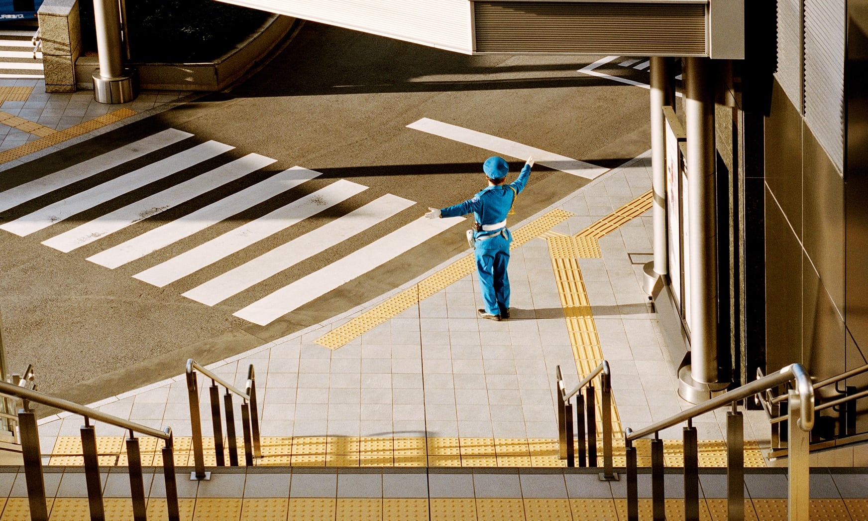 man directing traffic in japan shot from above