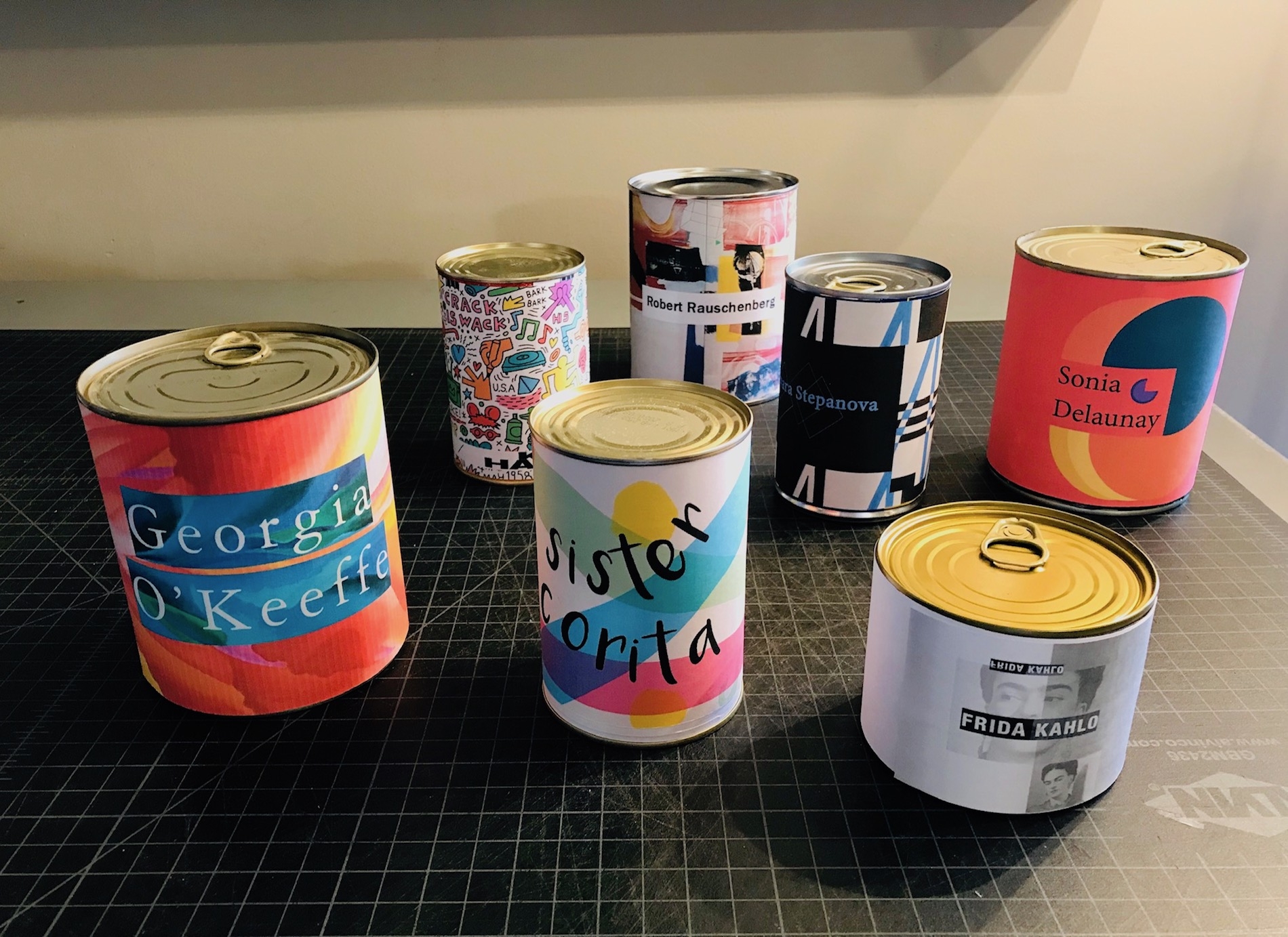 A photo of brightly colored cans devoted to different artists.