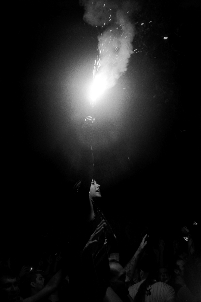 a protestor lighting a flare