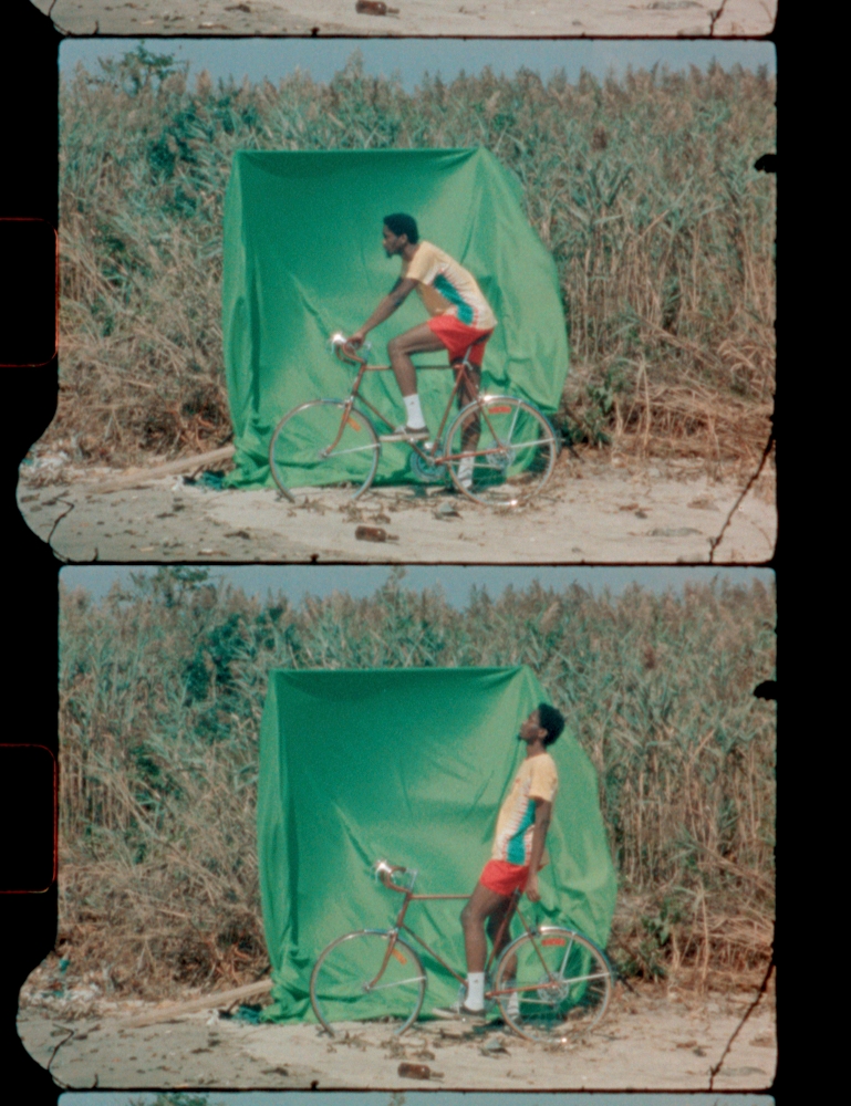man on bike with greenscreen at beach