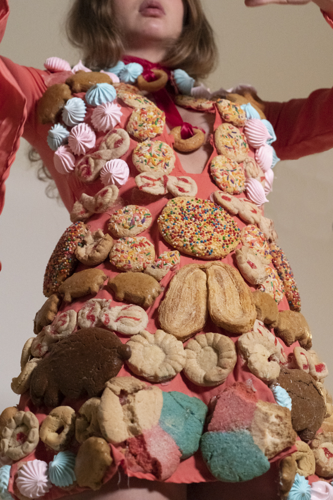 portrait of a woman covered and surrounded by pastries
