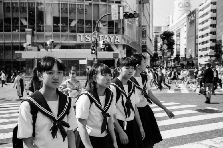 black and white photo of school children crossing the street