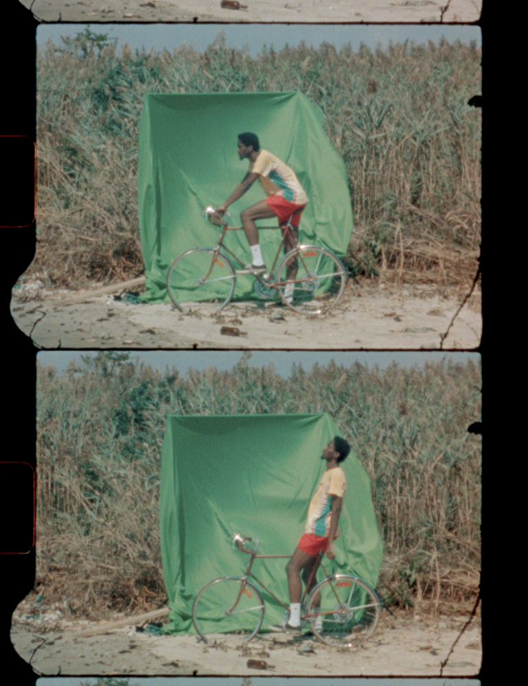 environmental portrait of a greenscreen background with cyclist