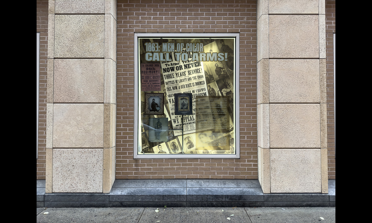 A photograph of a window containing other photographs and text from the book The Black Civil War Soldier by Dr. Deborah Willis