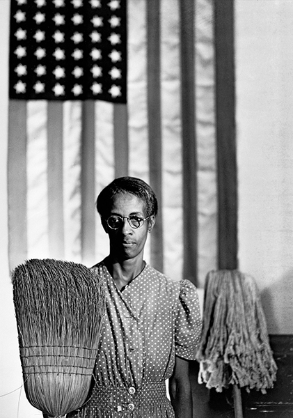 Ella watson holds mop and broom echoing grant wood's iconic american gothic painting