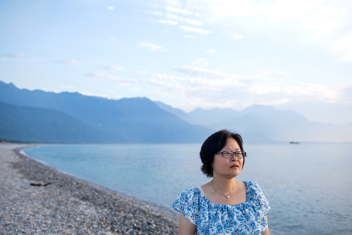 woman in front of lake and mountains