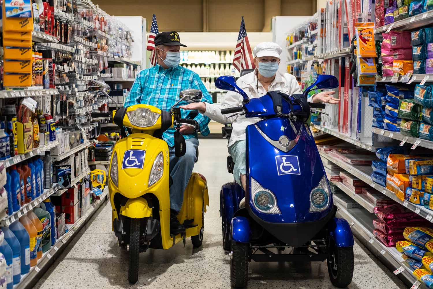 people with flags on scooters in supermarket