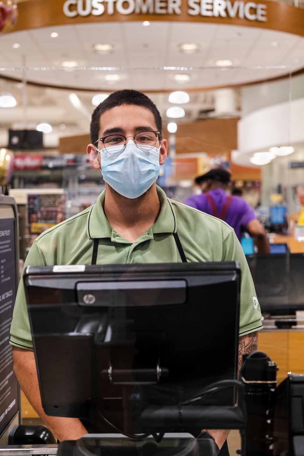 man in mask at checkout