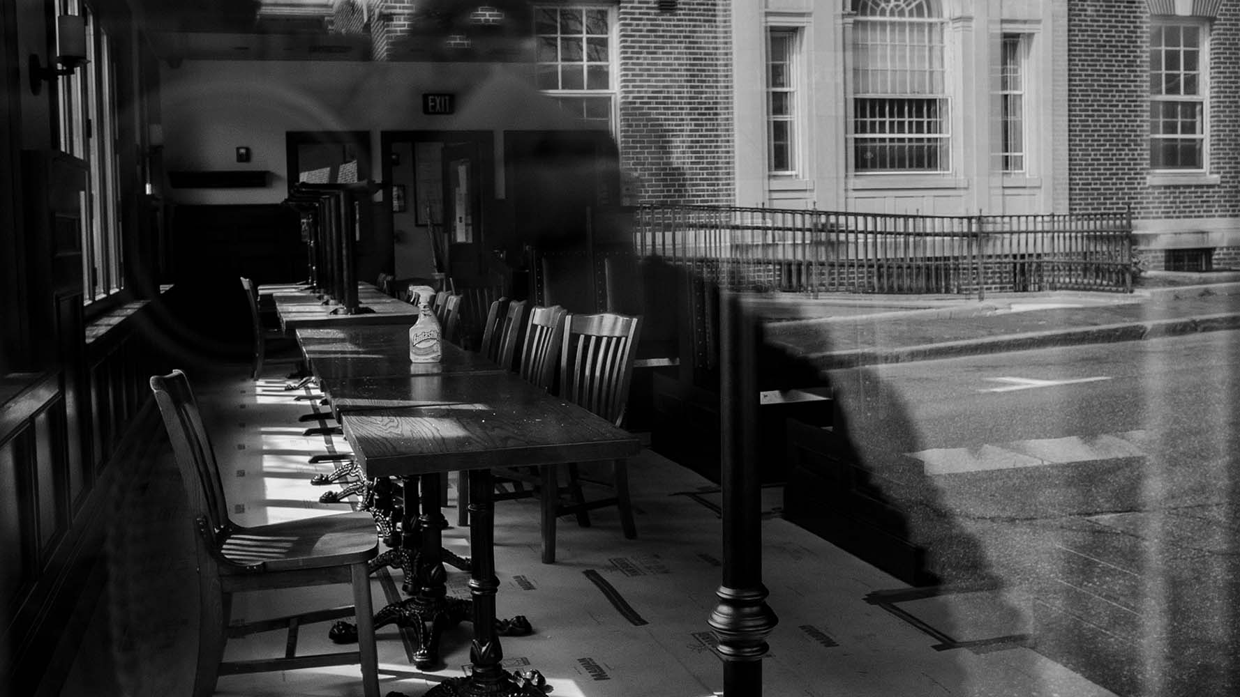 reflections in empty restaurant widnow in black and white