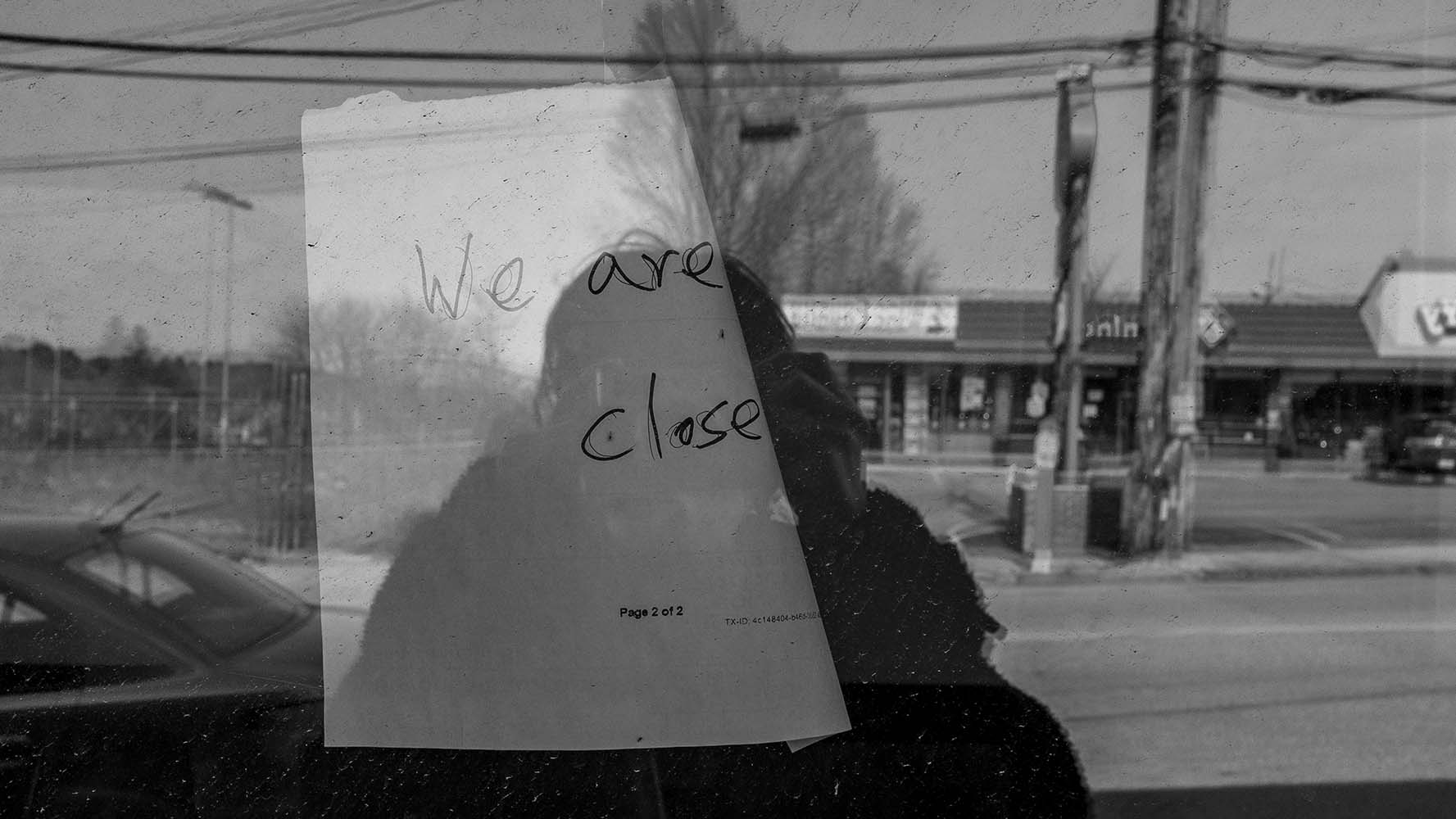 closed sign in shop window black and white