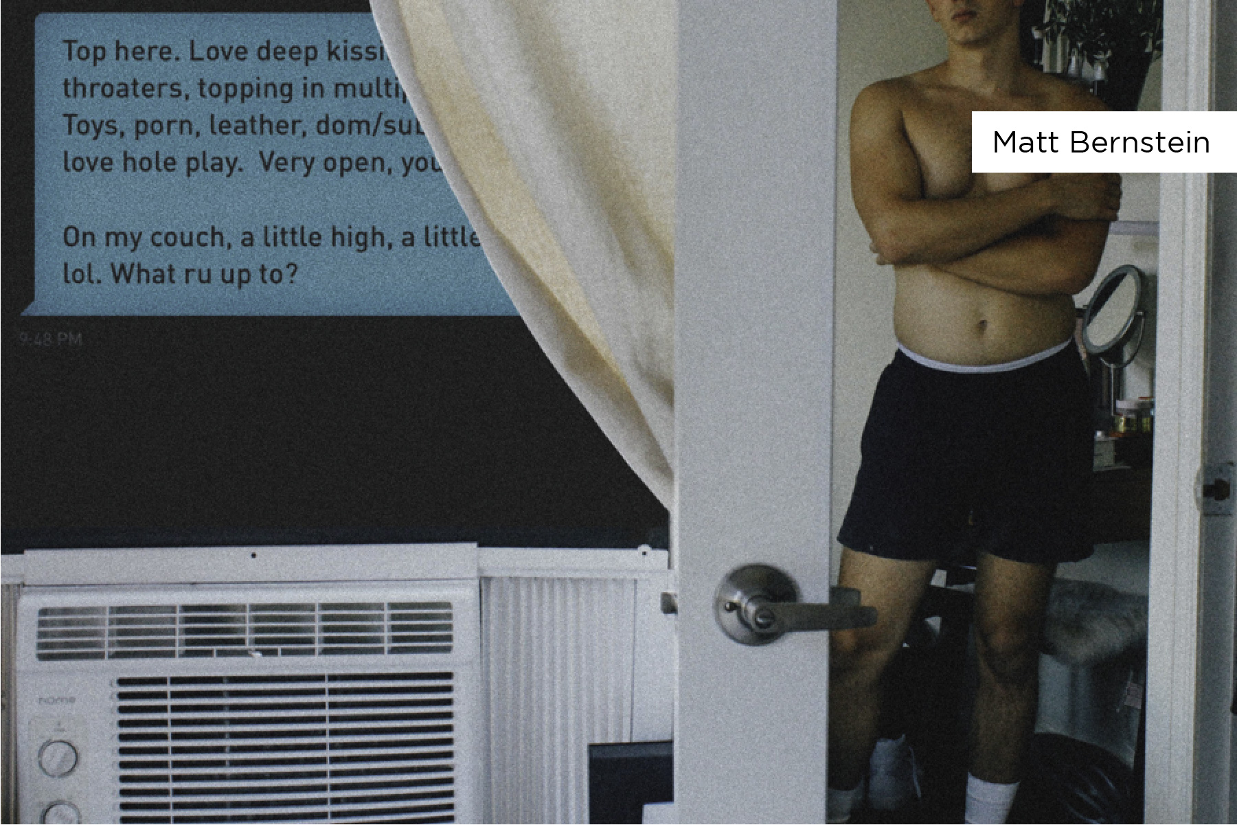 Environmental portrait of a man in underwear looking in a mirror