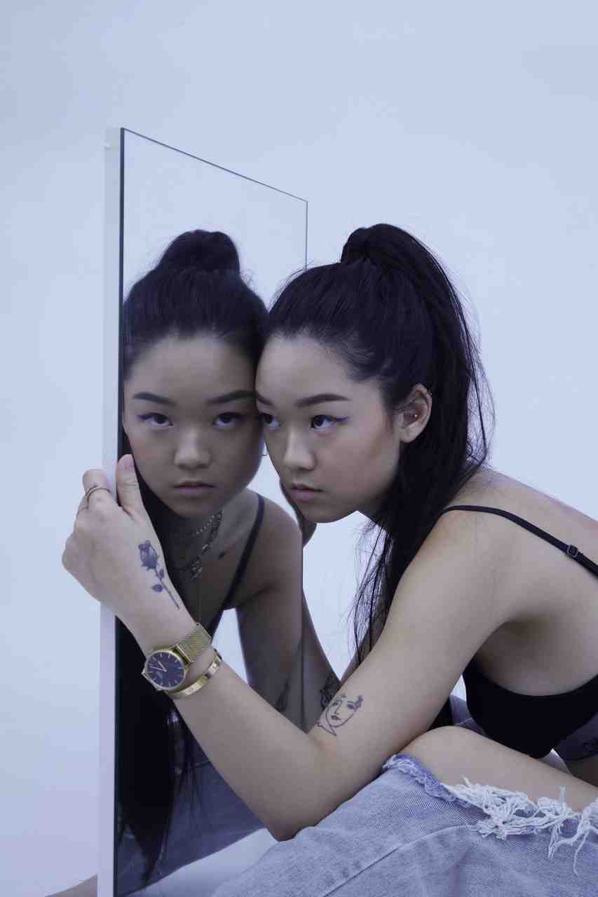 girl looking sideways in mirror