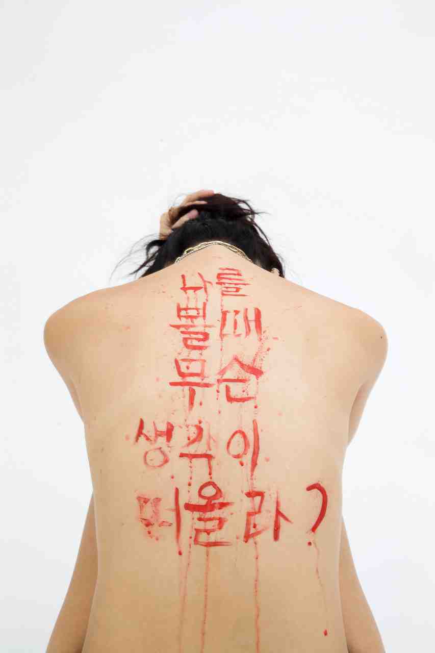 girl with red letters on back