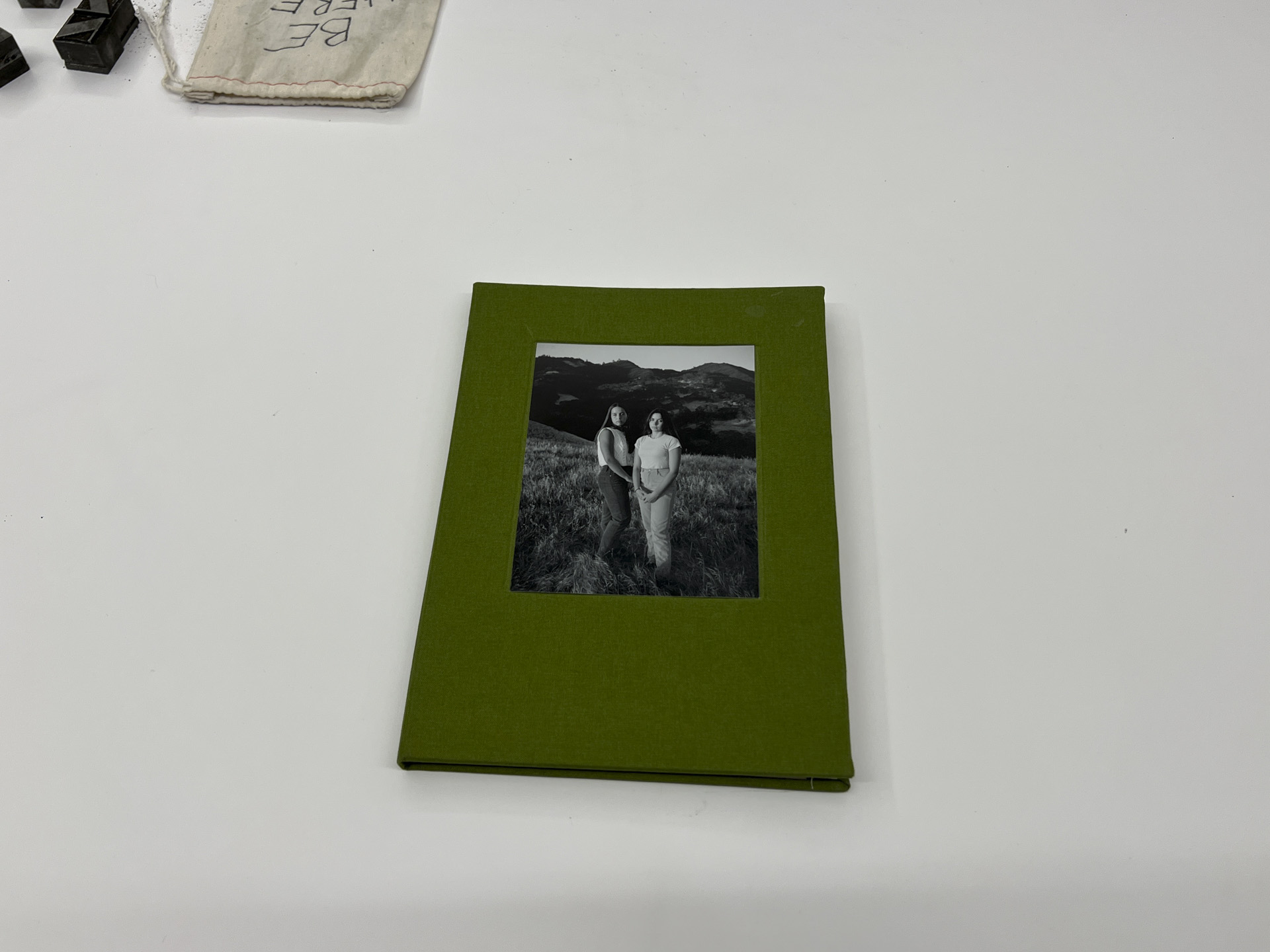 photo of a green book cover with portrait of two women