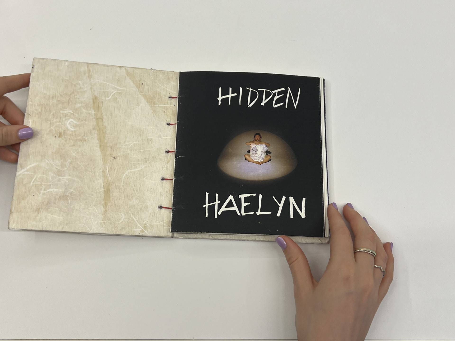 photo of a book opened with words "hidden haelyn" overlaid with photo of a woman