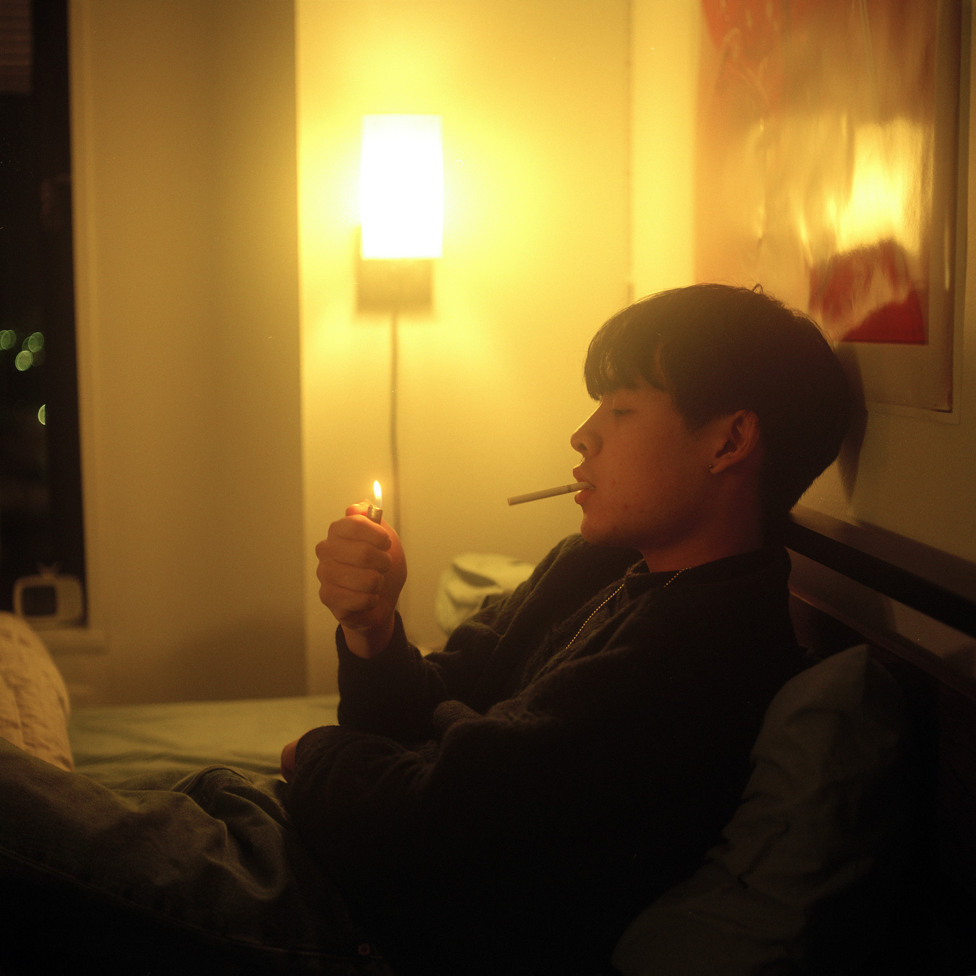 interior portrait person lighting a cigarette