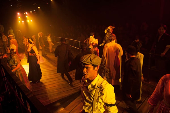 A musical theater performance with actors in period costume