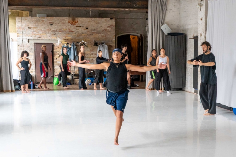 A dancer is running towards the camera during a training session in a dance studio