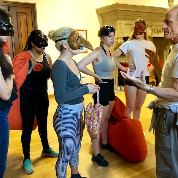 Jim Calder with students wearing various Commedia masks in Florence, Italy