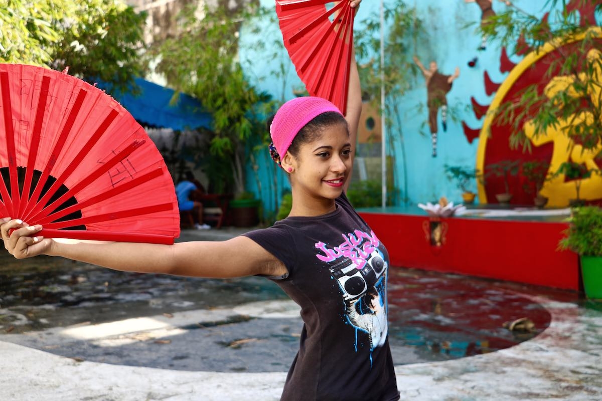 Dancer holding colorful fans in Cuba