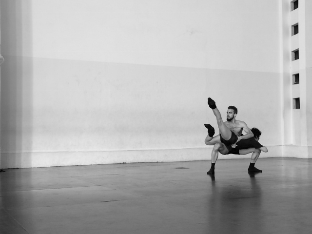 Black and white photo of two dancers in a studio.