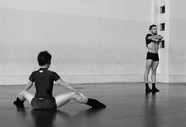 Black and white photo of two dancers in a studio.