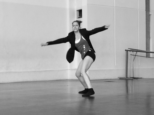 Black and white photo of a dancer in a studio.