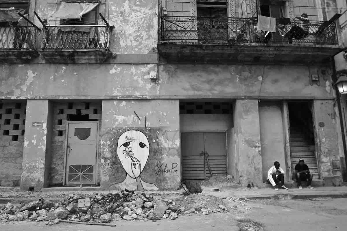 Black and white photo of graffiti in the streets of Havana.