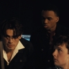 Three people looking at a computer.