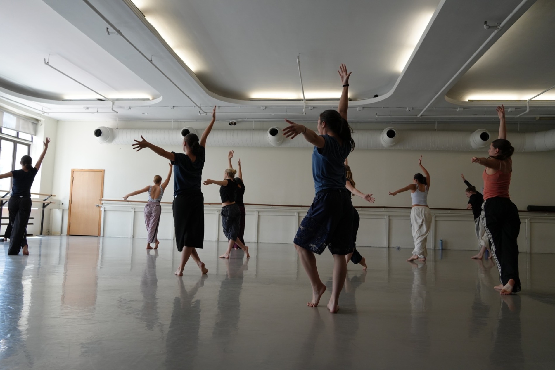 Group of dance students training in a rehearsal studio