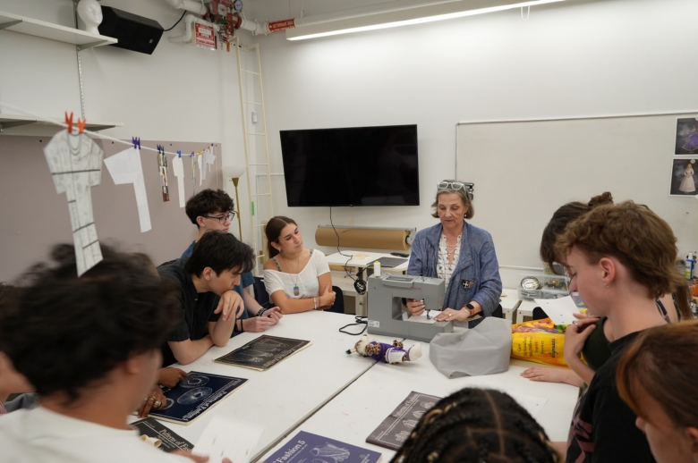 Students being assisted by instructor during class project