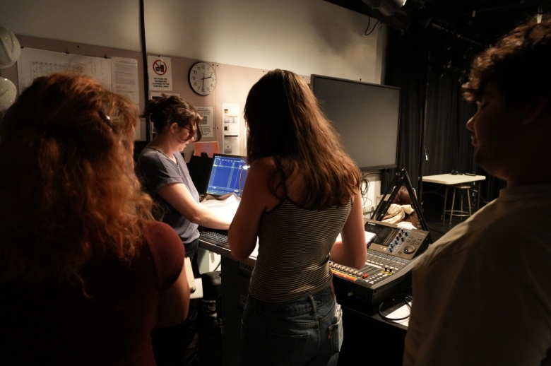 Students being assisted by instructor during class project