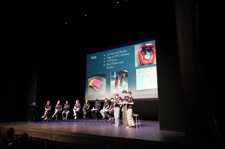 Students on stage during final presentations