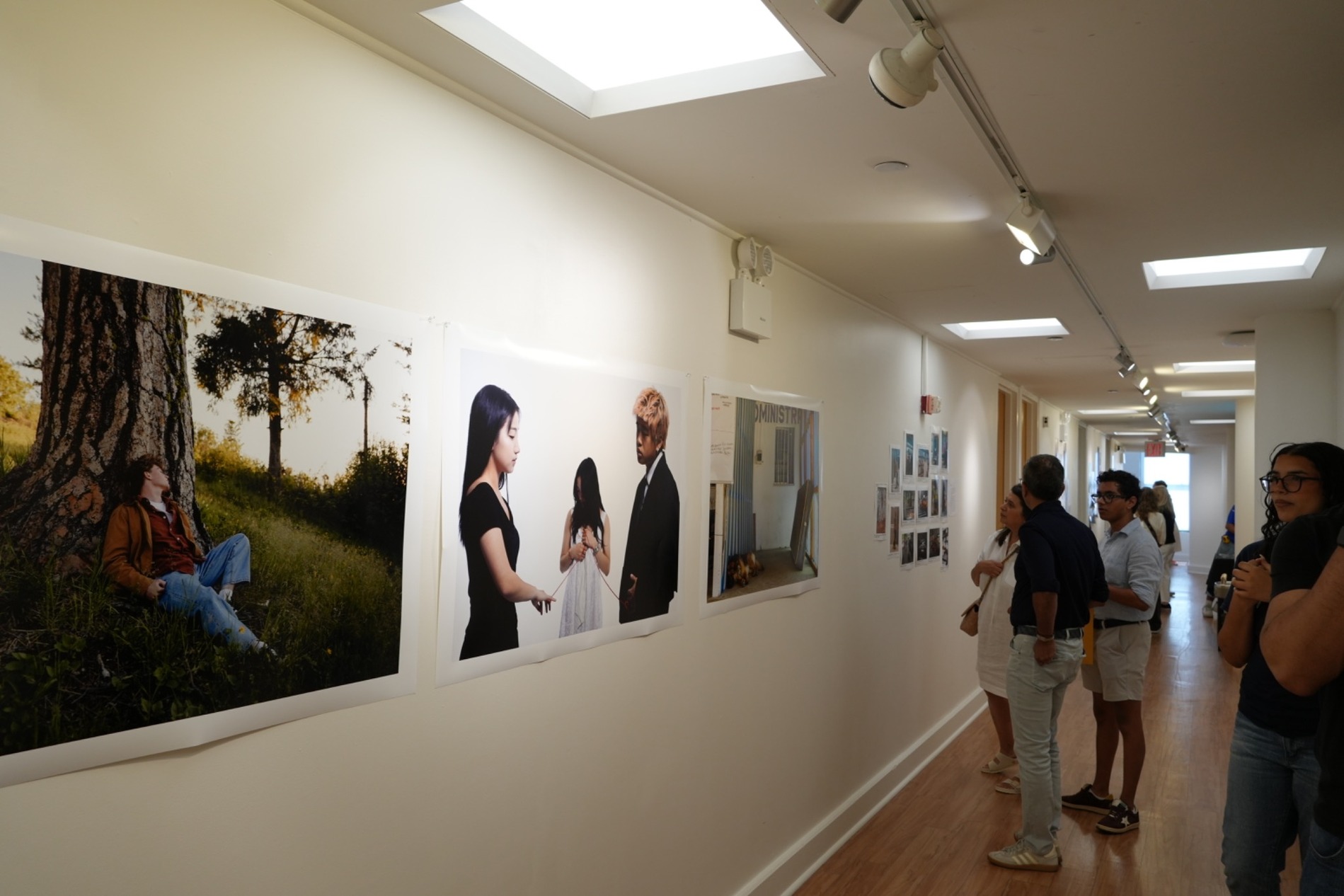 Guests view a display of the Tisch Summer Photography students' work