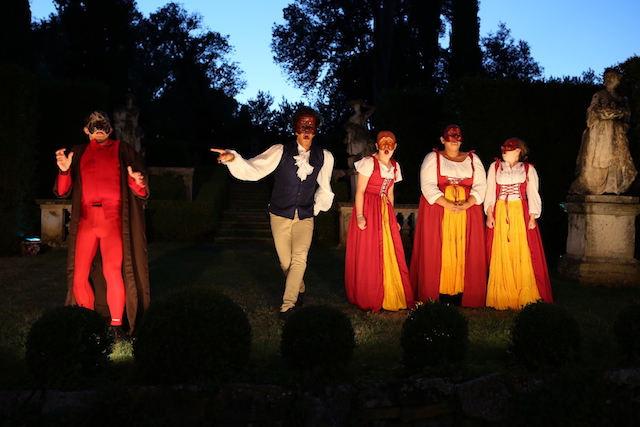 Outdoor performance in Florence with four students acting in traditional Commedia masks.