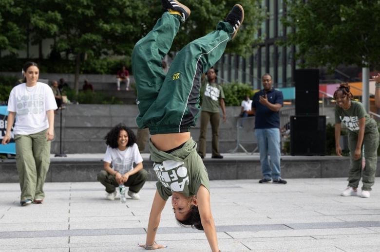 Ladies of Hip-Hop soloist doing a handstand during an outdoor performance