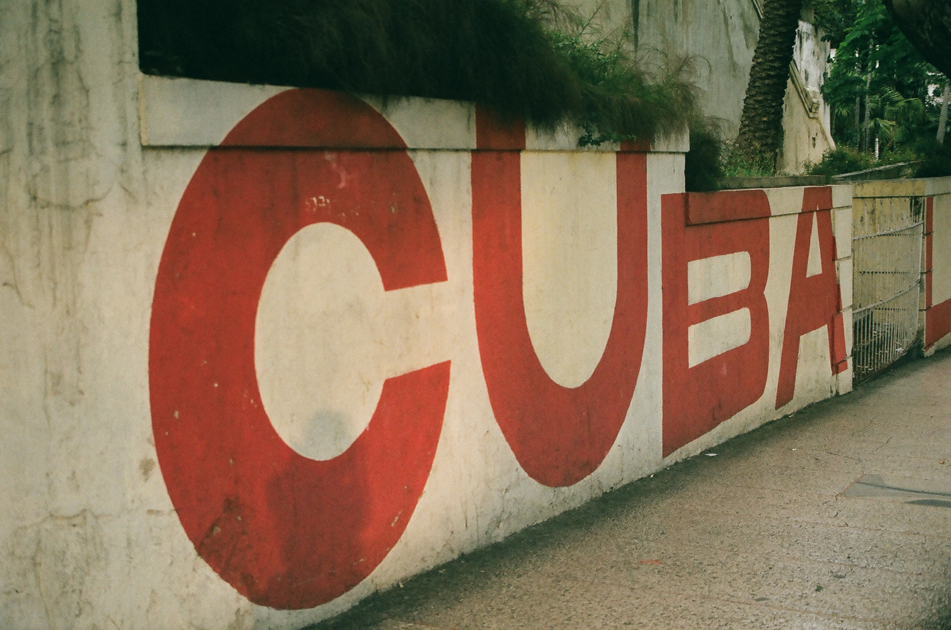 The word "Cuba" painted in red block letters on a wall in Havana.