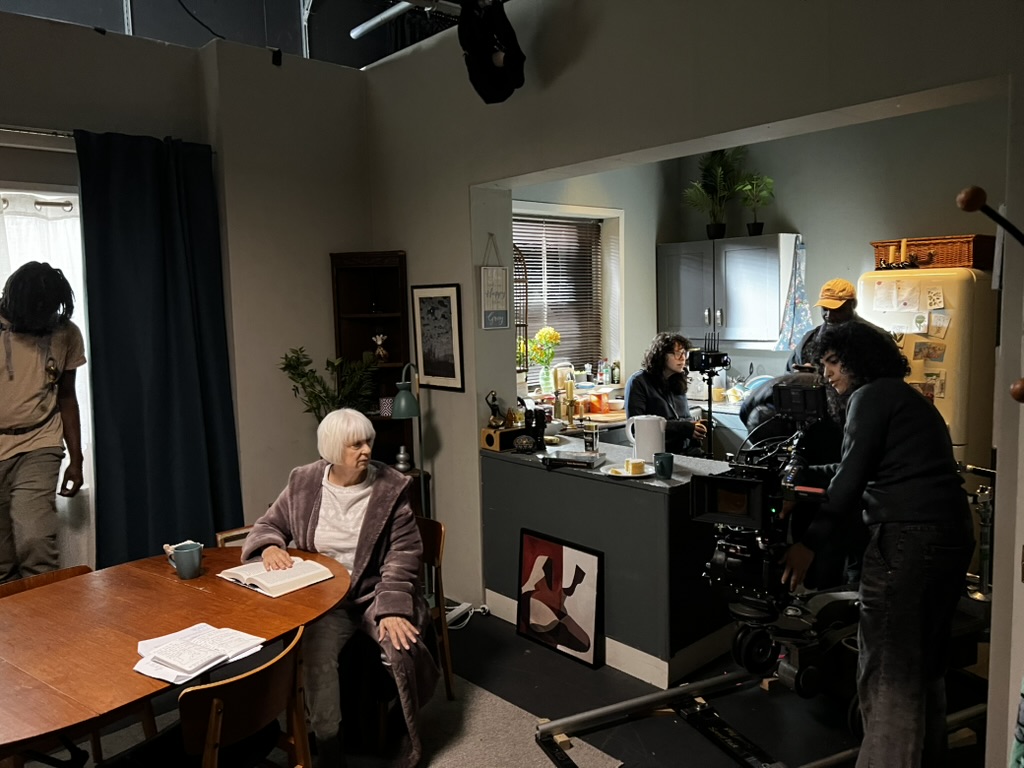 The NFTS professional crew doing finishing touches on a scene as an actor prepares herself