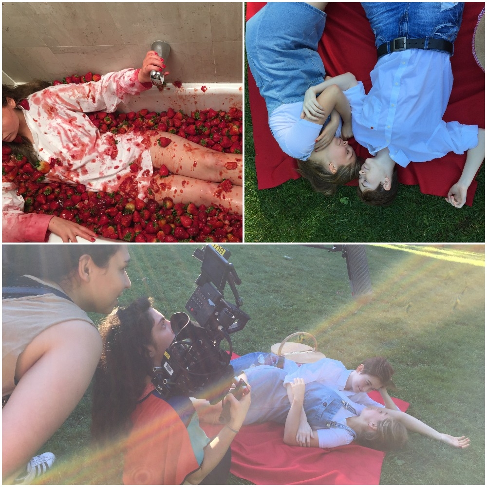 Images of a woman lying in a bathtub full of strawberries; two women lying on a picnic blanket outside; and a filmmaker shooting a scene with the two women on the picnic blanket