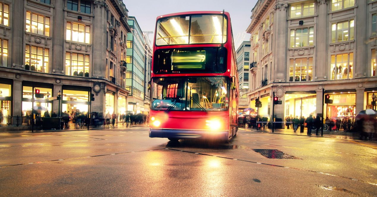 Image of a red double-decker bus on a street in London.