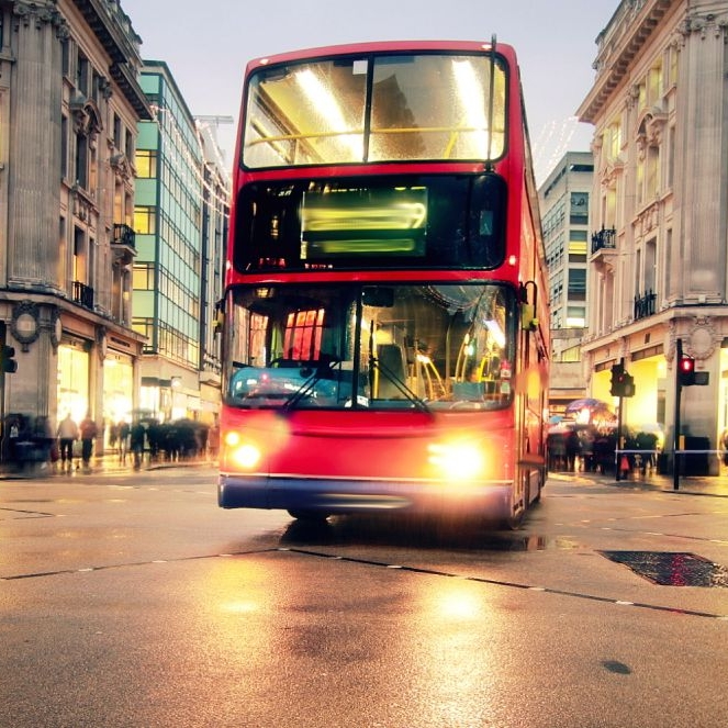 Image of a red double-decker bus on a street in London.