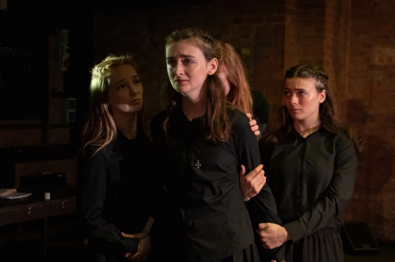 Actresses holding another actresses' arm during a scene from the Spring 2026 final presentation of "Measure for Measure".