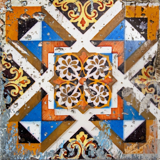 Orange, blue, and white geometric ceramic tiles in Havana.