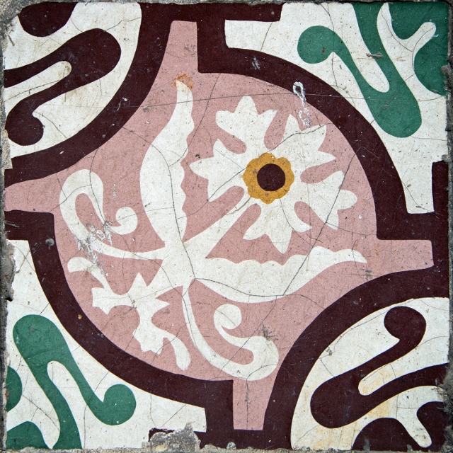 Pink, white, black, and green floral painted ceramic tiles.