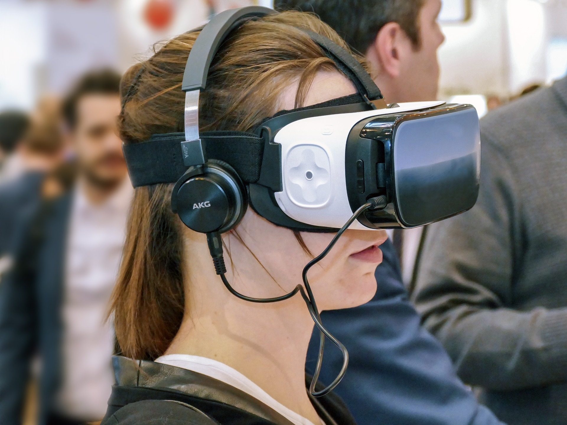 Woman wearing a VR set and headphones.