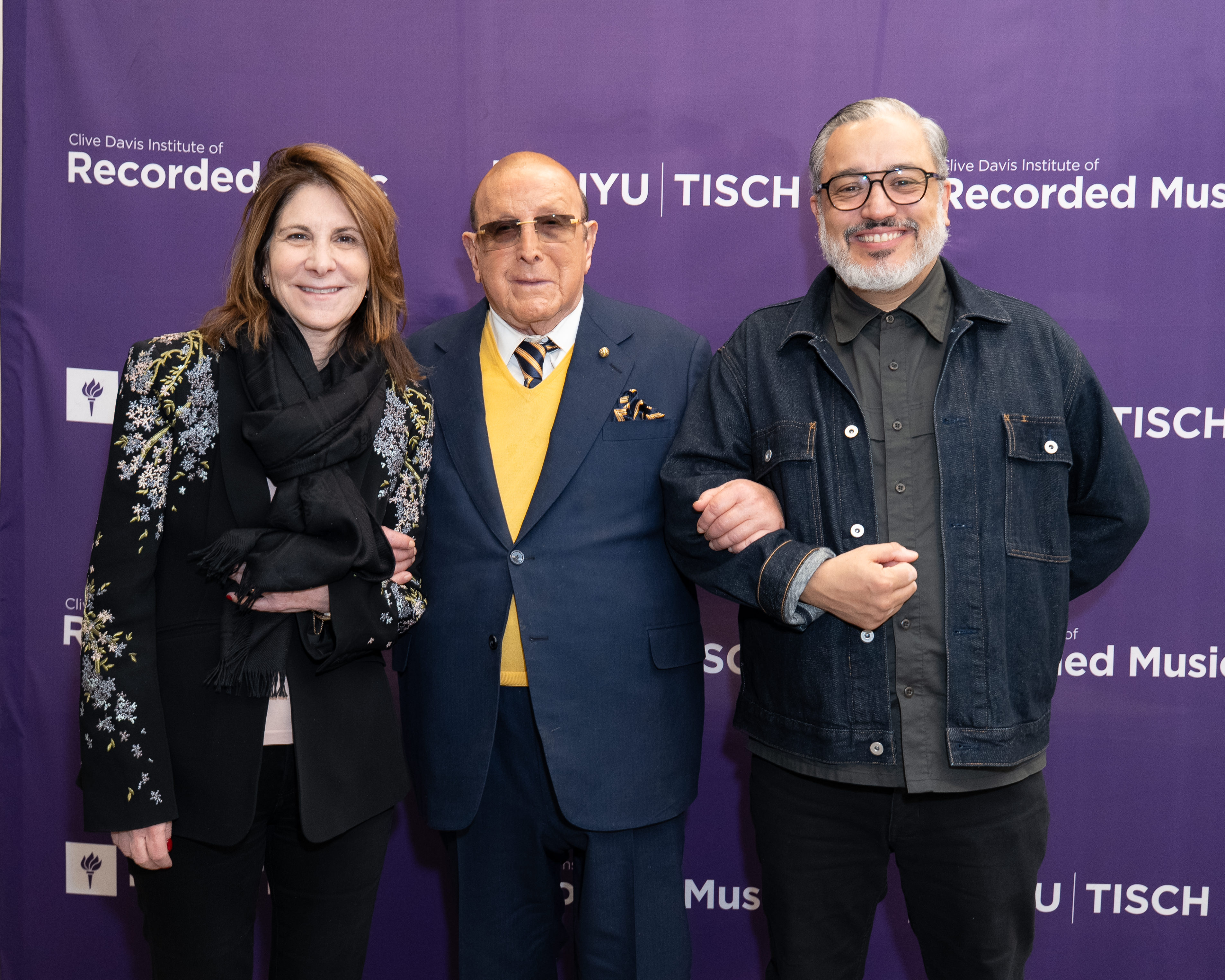 NYU President LInda Mills, Clive Davis, and Tisch Dean Rubén Polendo. 