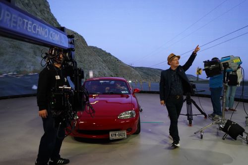Instructor Noah Kadner teaching Car Process workshop with a red sports car in front of the LED wall